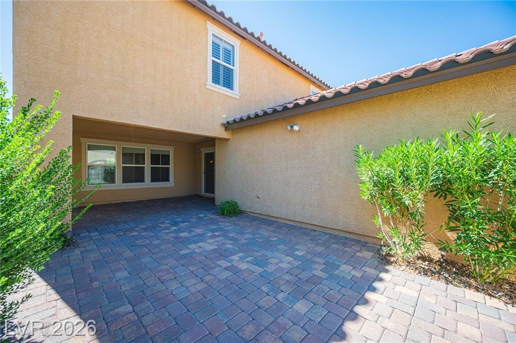 Paver courtyard between the house and the garage