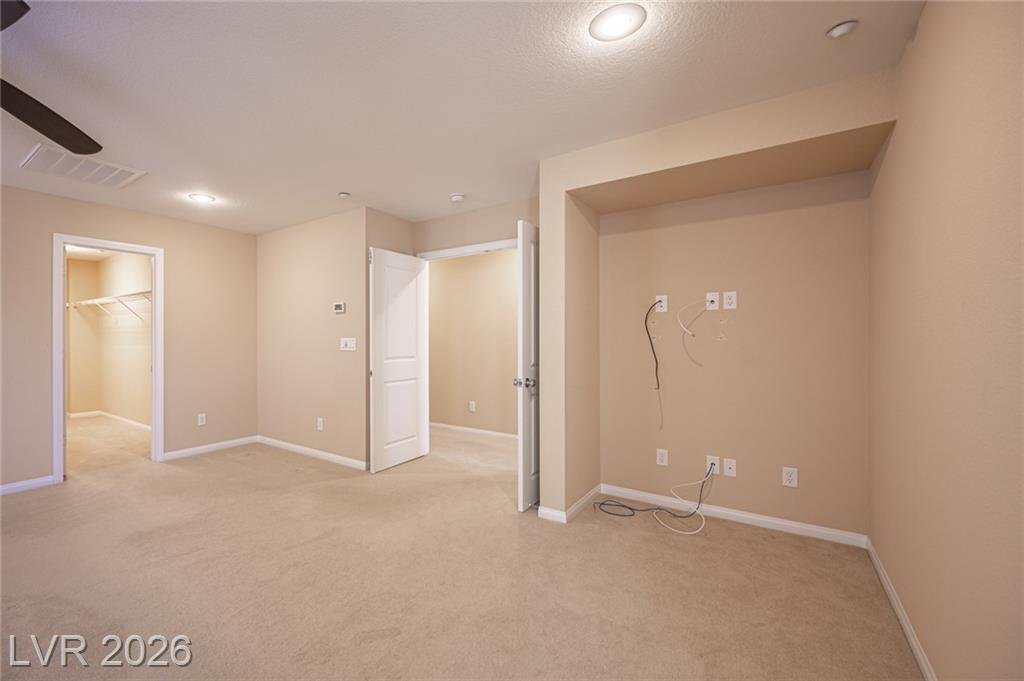Primary bedroom corner with the closet door open
