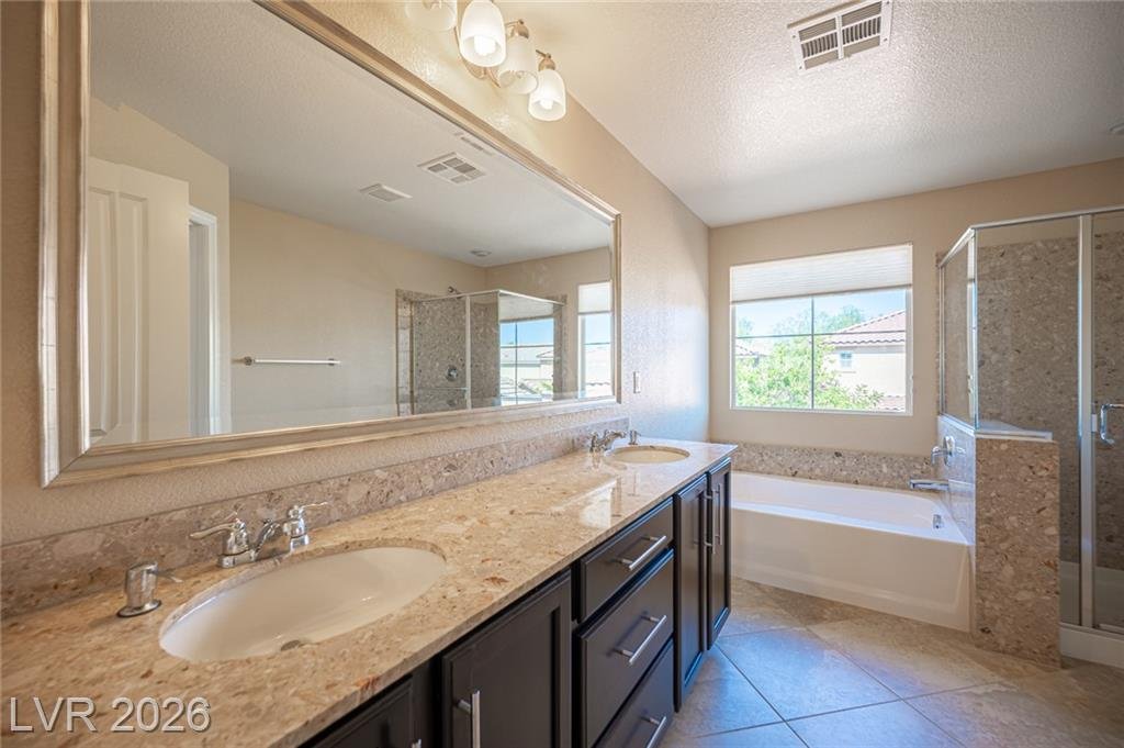 Primary bath double vanity at 3198 Sisley Garden Avenue