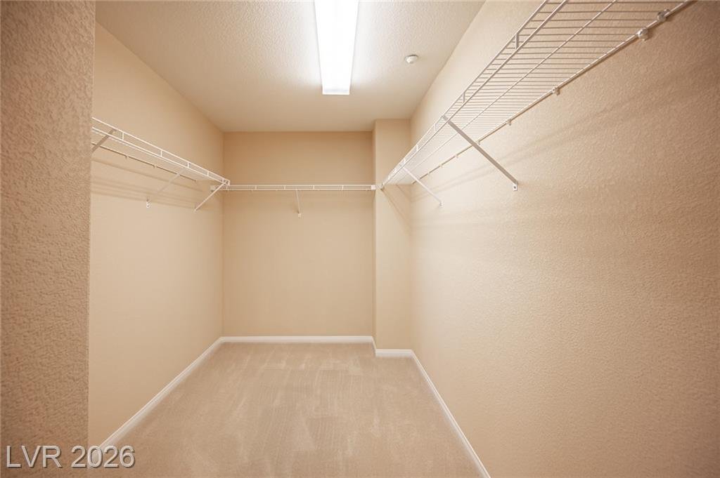 Primary walk-in closet with wire shelving