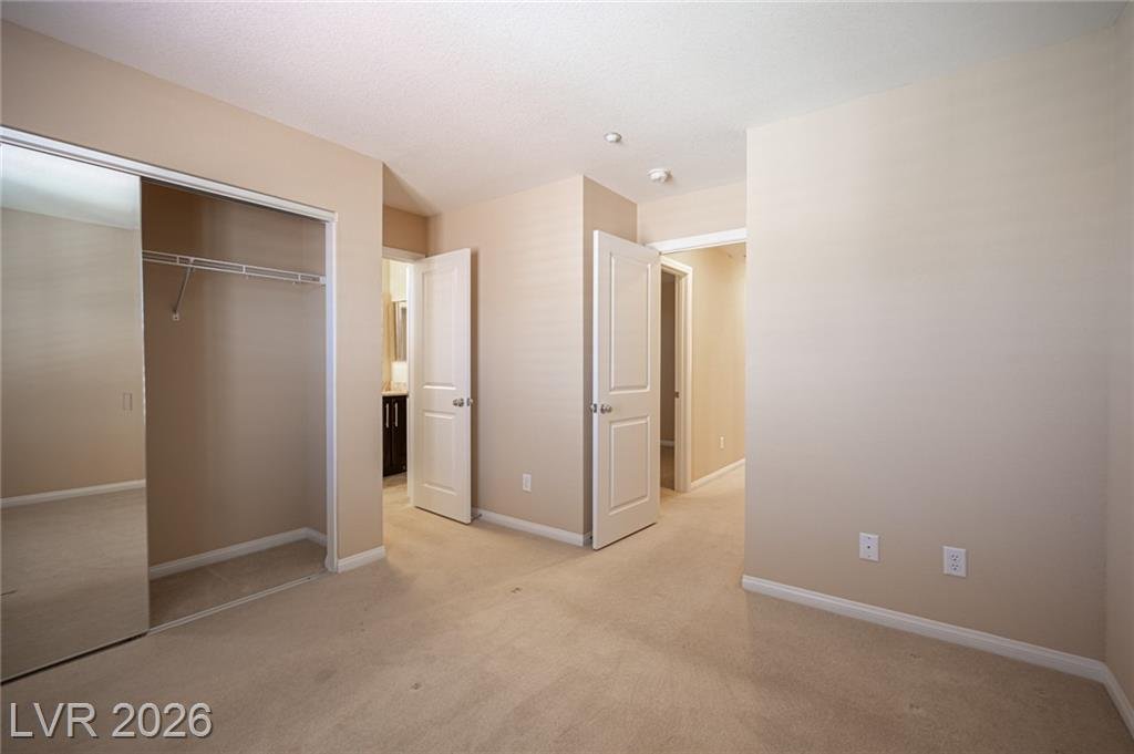 Secondary bedroom with a mirrored closet