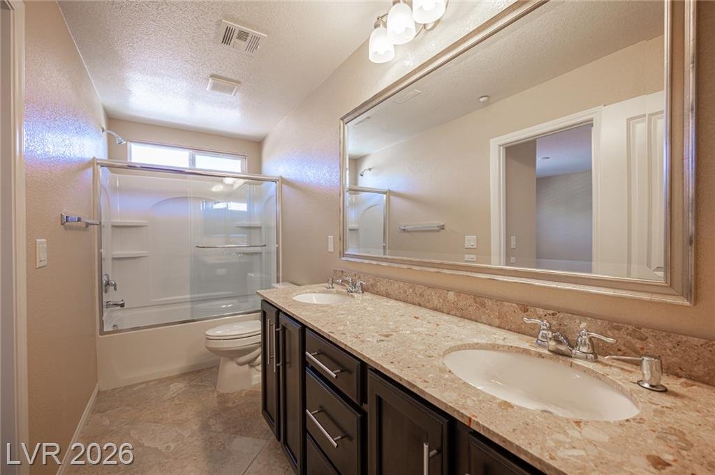Upstairs hall bath at 3198 Sisley Garden Avenue with a double sink vanity