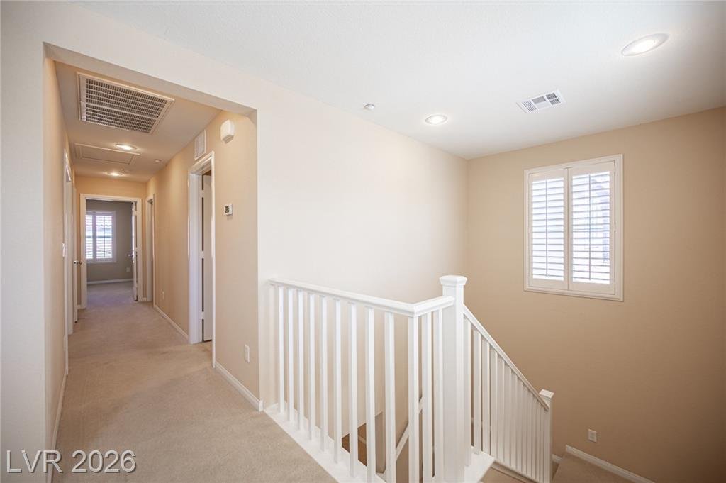 Upstairs hallway past the stair railing