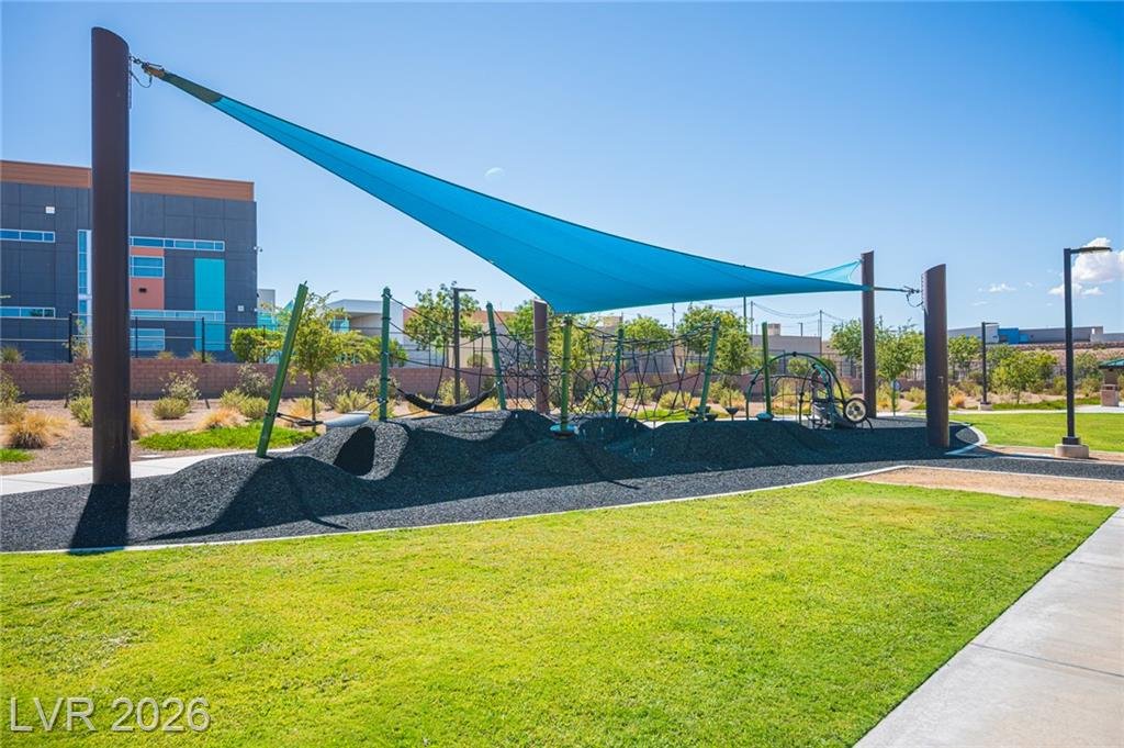 Shade sails over a park play area and lawn
