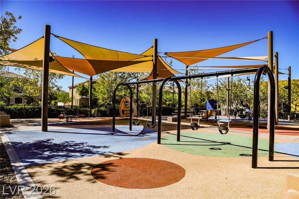 Swing set under colorful shade sails