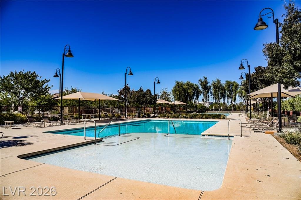 Resort-style community pool deck and loungers