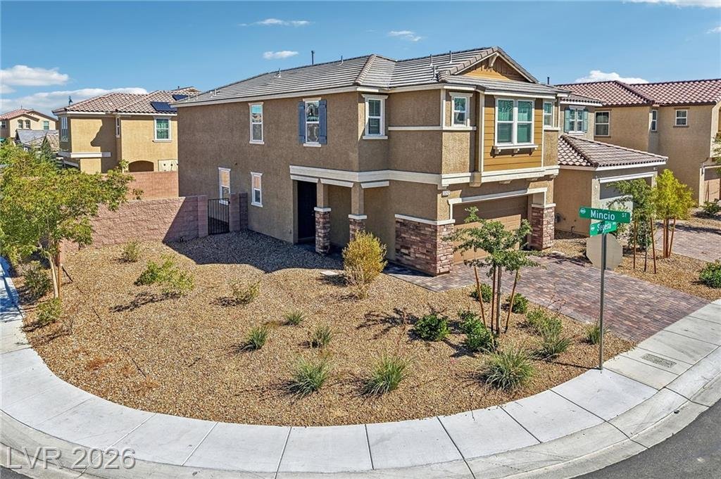 Corner-lot desert landscaping wrapping the front of 3212 Segesta Avenue
