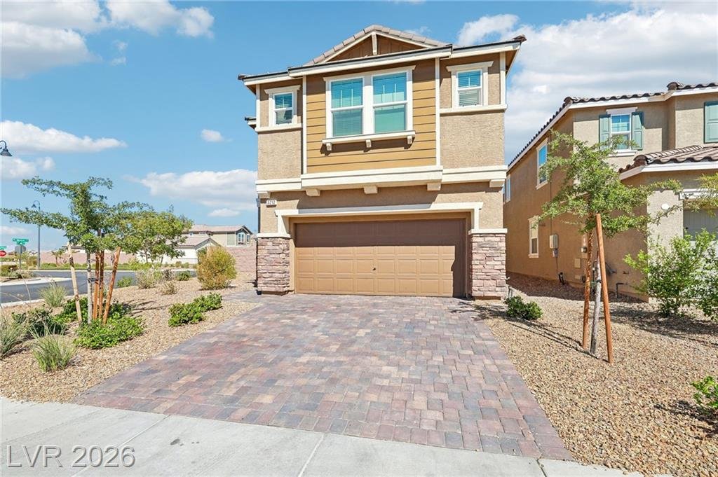 Two-story front elevation with a paver driveway and two-car garage