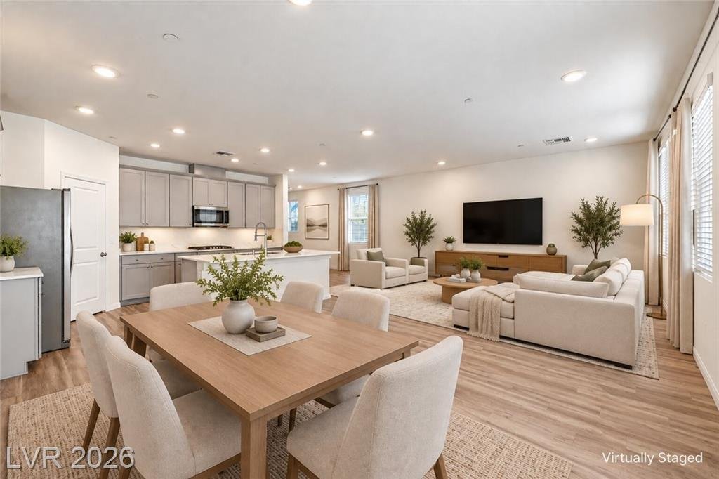 Dining area between the kitchen and great room, virtually staged