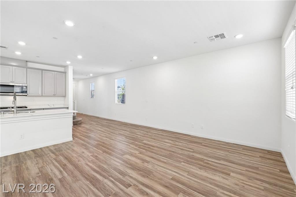 Great room with side windows and wood-look vinyl flooring at 3212 Segesta Avenue