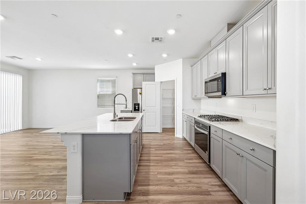 Full wall of gray shaker cabinets and stainless appliances at 3212 Segesta Avenue