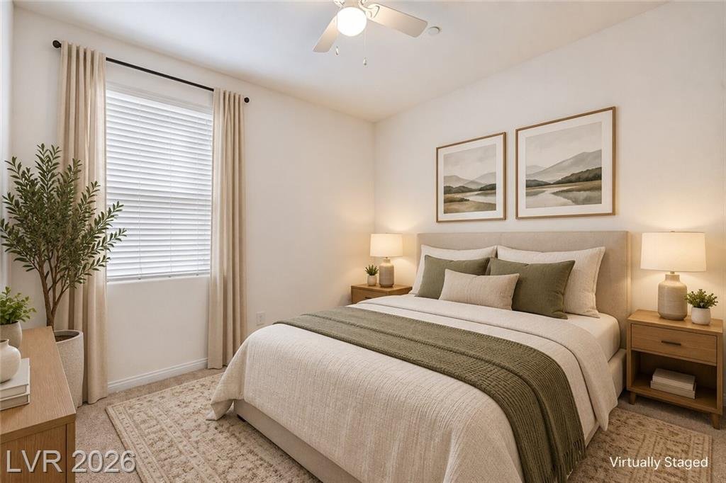 Downstairs bedroom with a ceiling fan, virtually staged