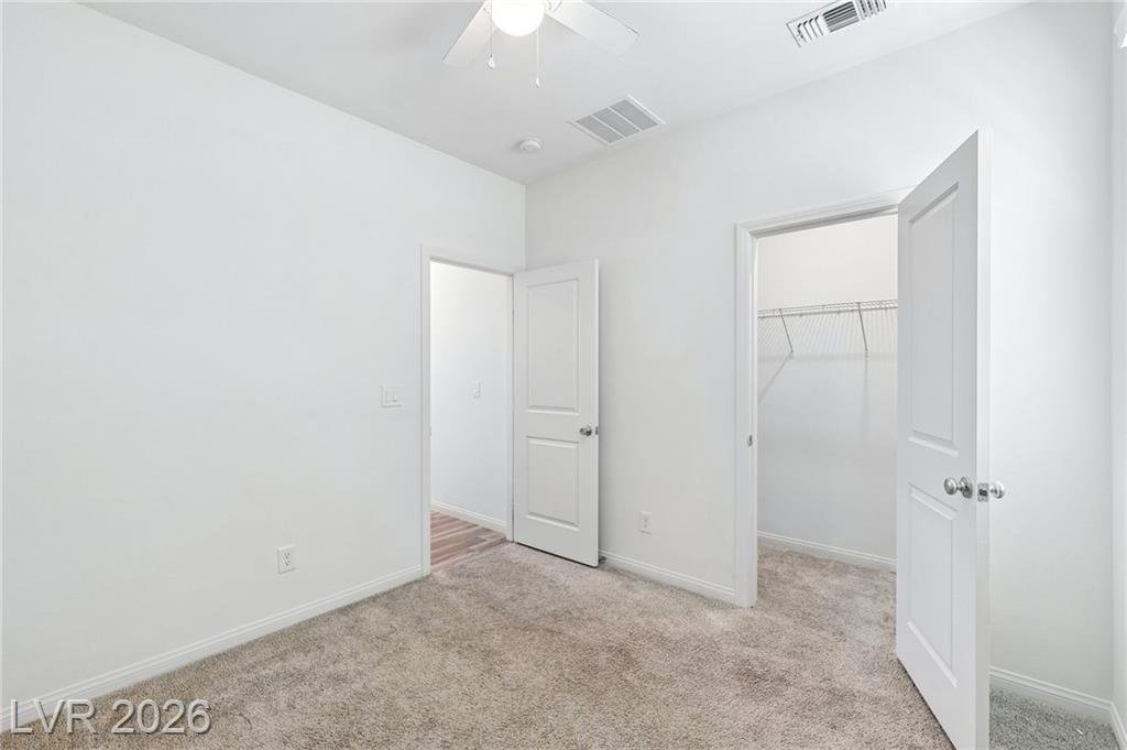 Downstairs bedroom with its walk-in closet door open