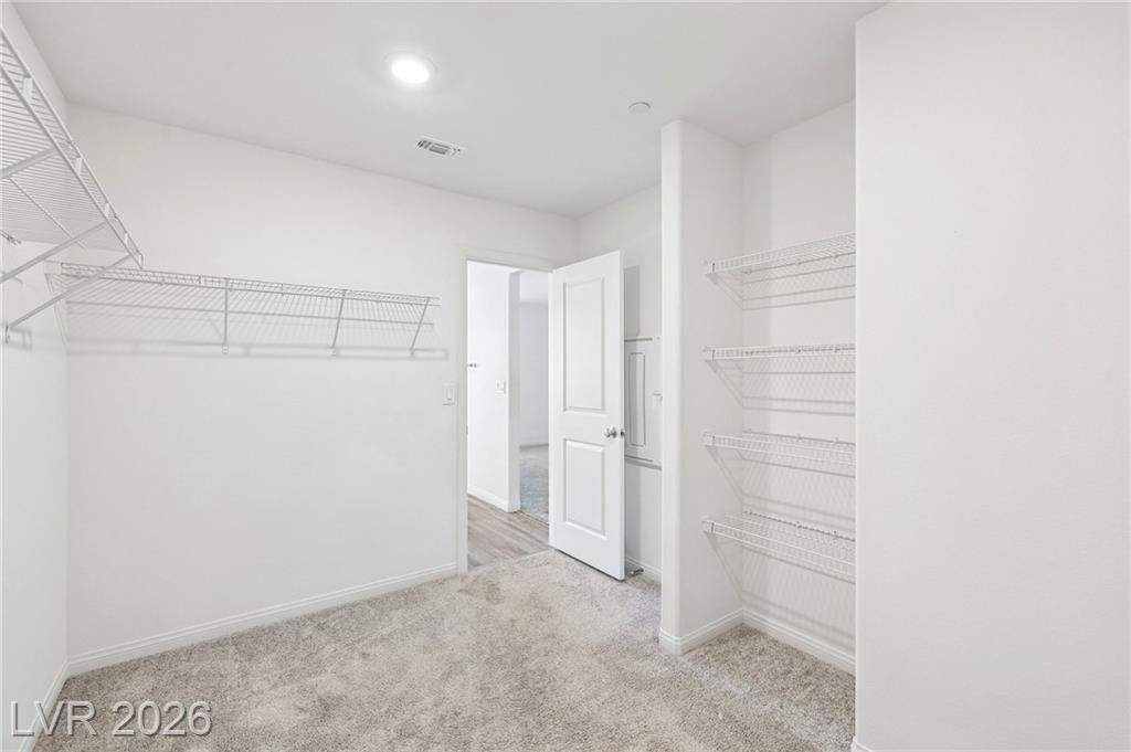 Primary closet shelving toward the bath