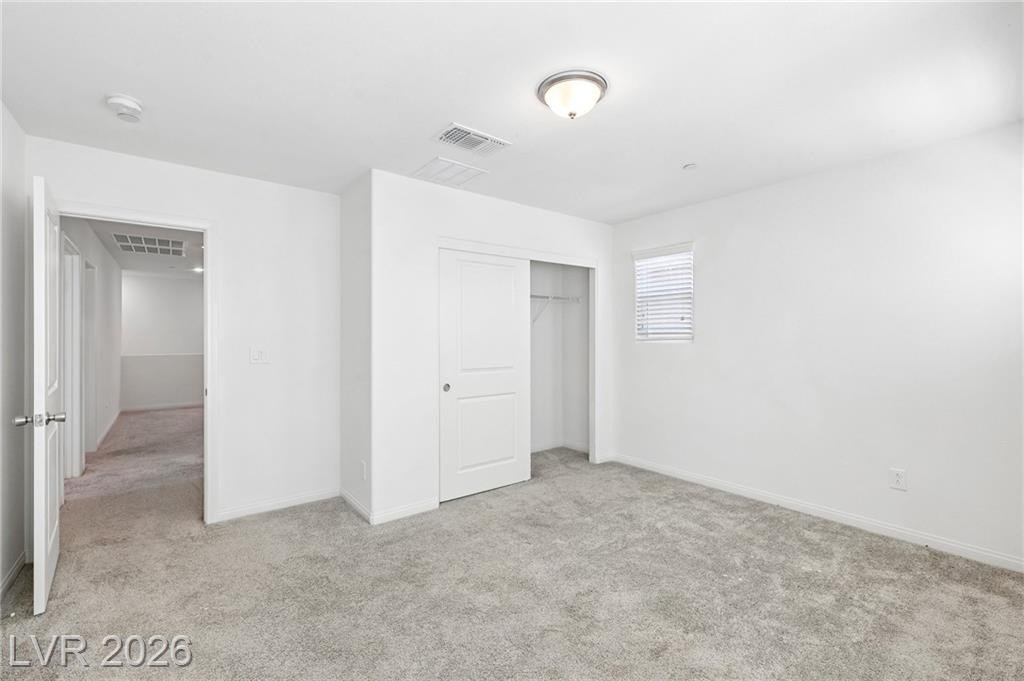 Front bedroom closet and doorway to the hall