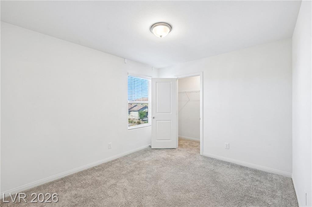 Secondary bedroom with a walk-in closet at 3212 Segesta Avenue