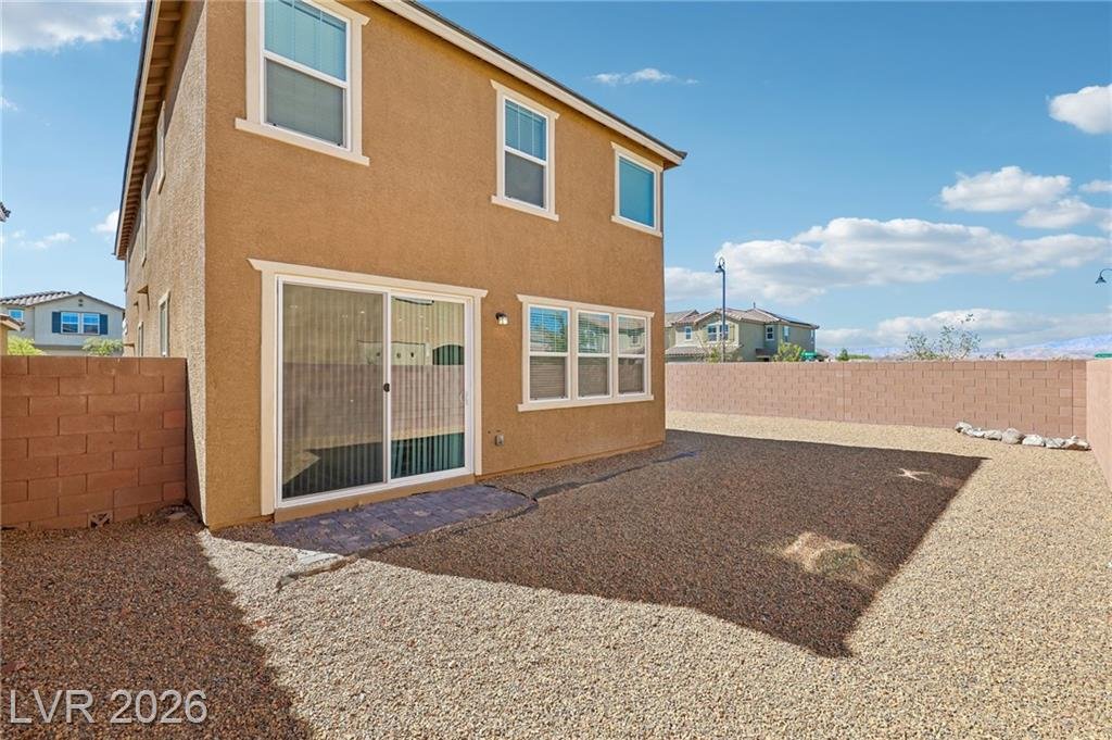 Rear sliding door opening to the gravel backyard