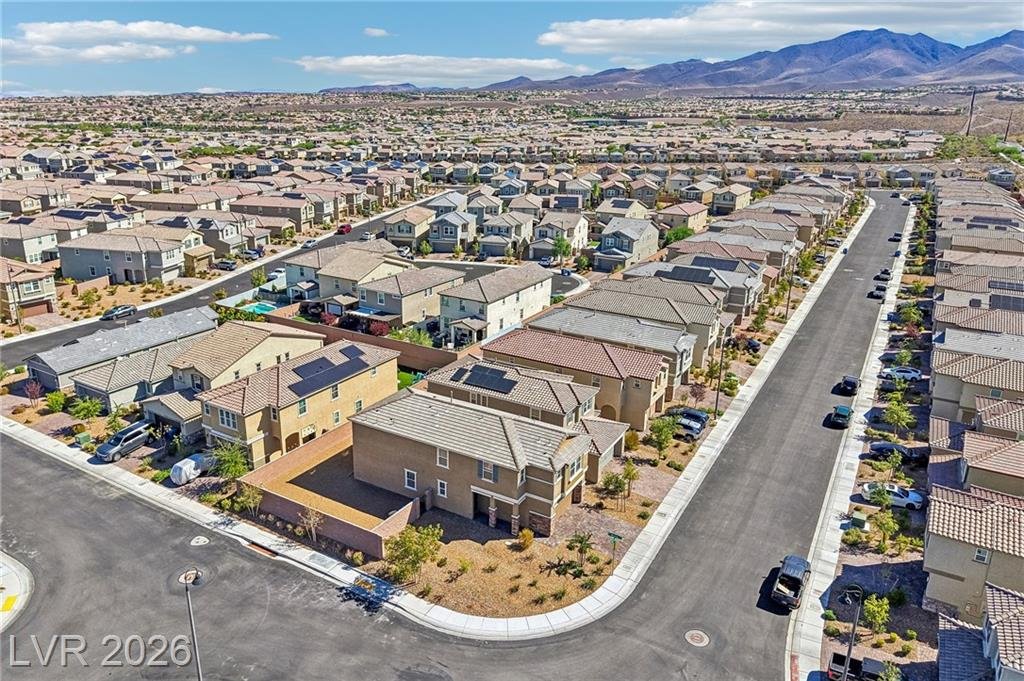 Aerial of the corner lot and curved street toward the mountains