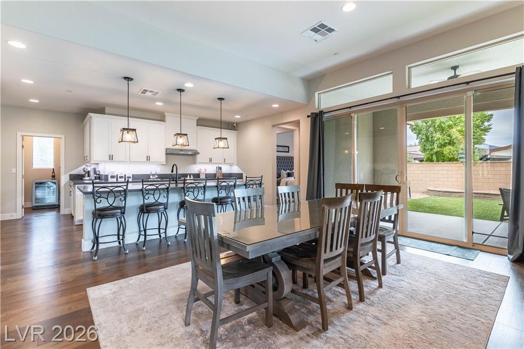 Kitchen island with bar seating beside the dining area and sliding doors