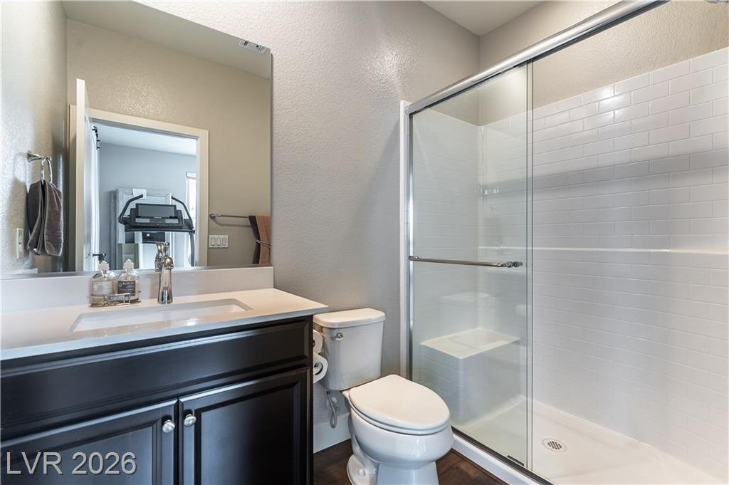 Downstairs bathroom with glass shower and dark vanity