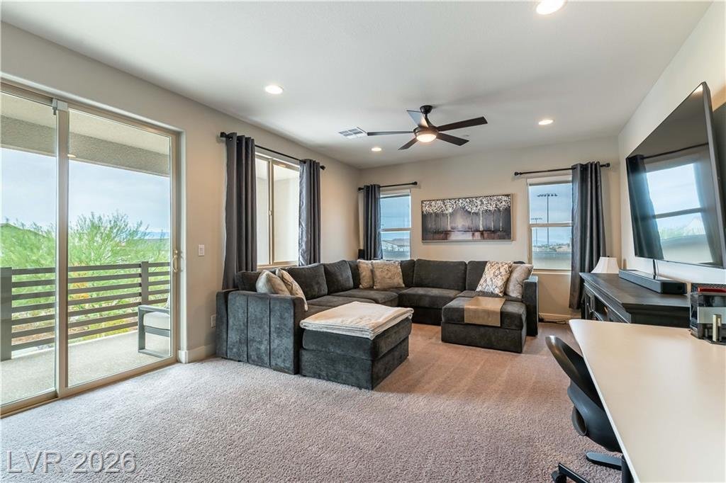 Upstairs loft with sectional and sliding door to the balcony at 2114 Maderno Street