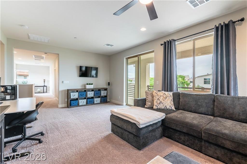 Loft media area with desk, sectional and wall-mounted TV