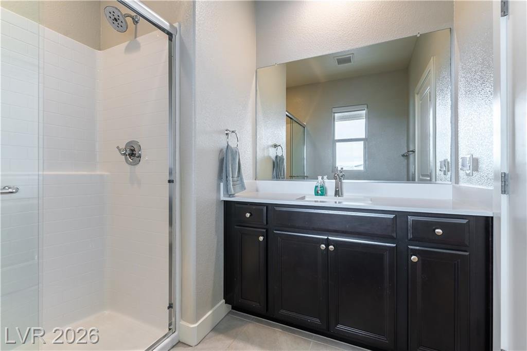 Upstairs bathroom with walk-in shower and dark vanity