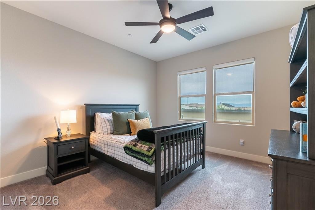 Upstairs bedroom with double windows and carpet