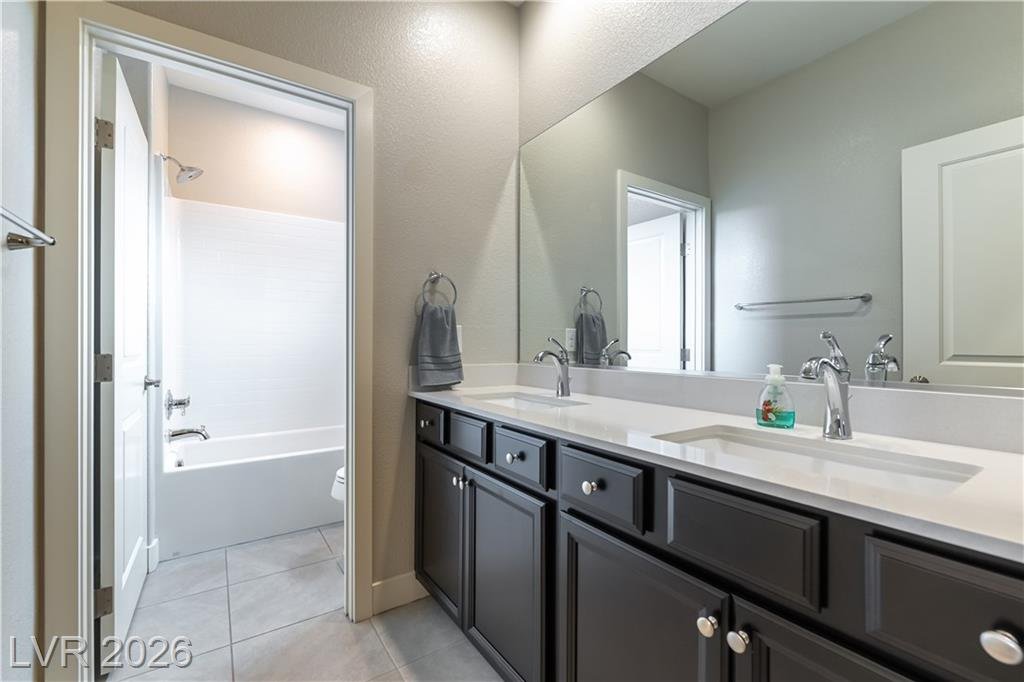 Bathroom with dual sinks, quartz counter and separate tub room