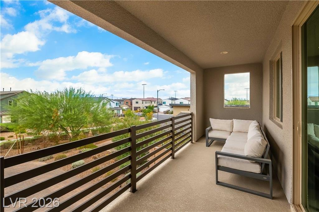 Covered upstairs balcony with outdoor seating overlooking Inspirada