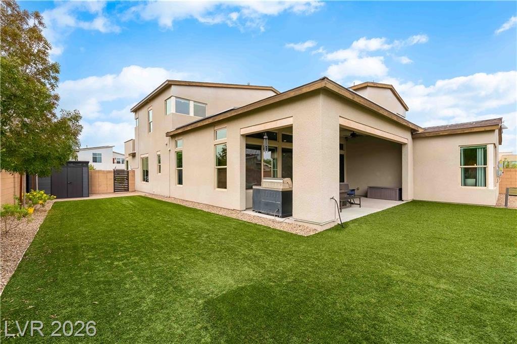 Backyard with synthetic turf and oversized covered patio in Inspirada