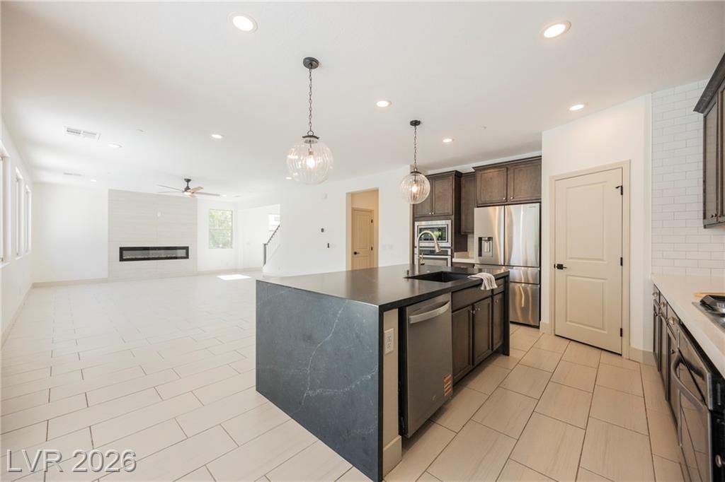 Kitchen island looking out to the great room and fireplace at 2430 Quiet Ode Street