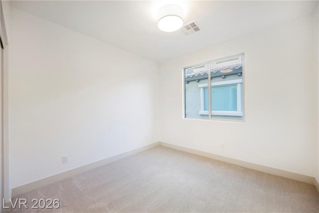 Downstairs bedroom with new carpet and drum ceiling light