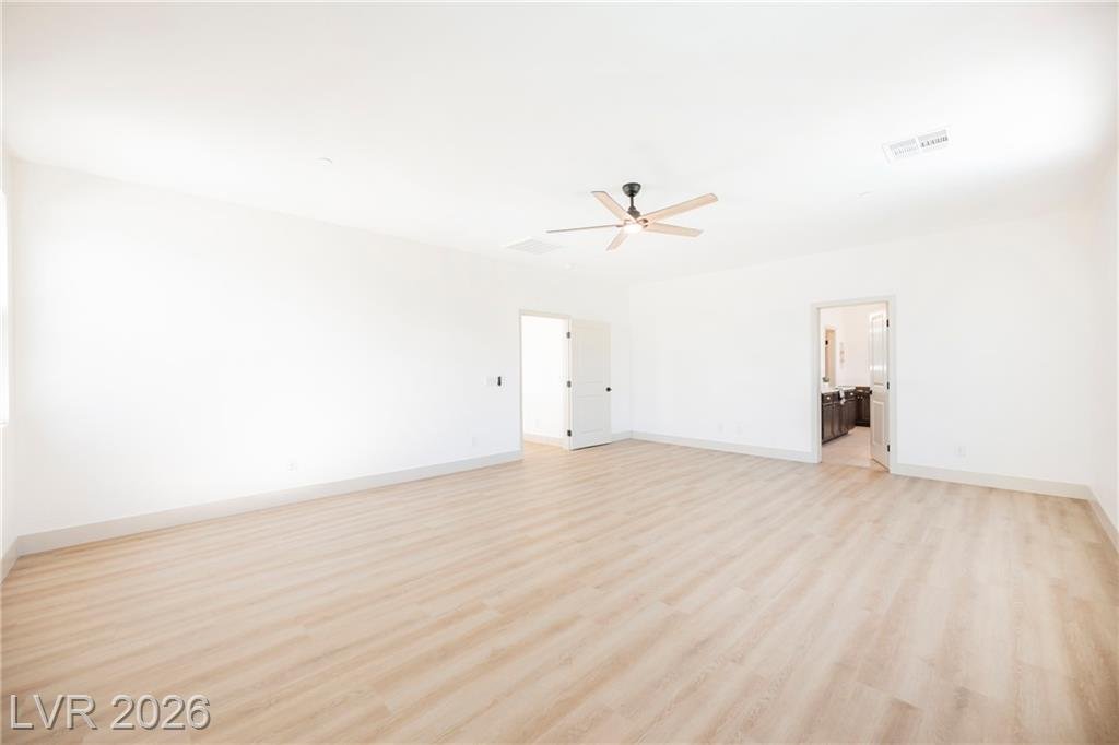 Primary bedroom opening to the bath and walk-in closet at 2430 Quiet Ode Street