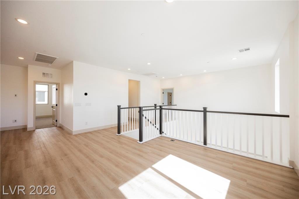 Loft opening to the upstairs hallway with plank vinyl floors