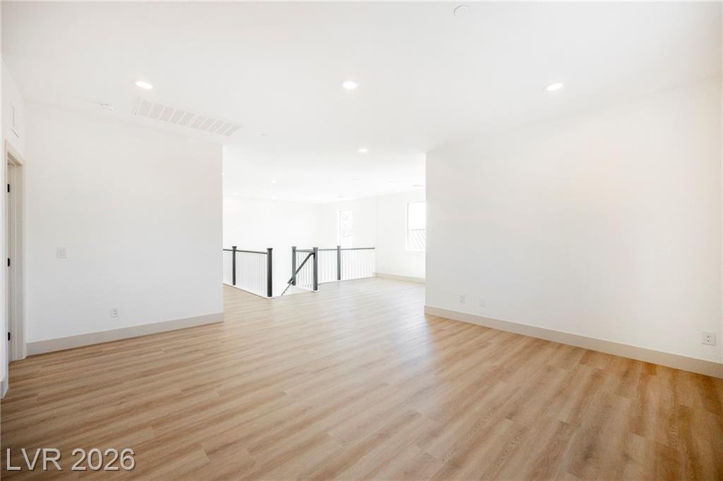 Large open loft area with recessed lighting