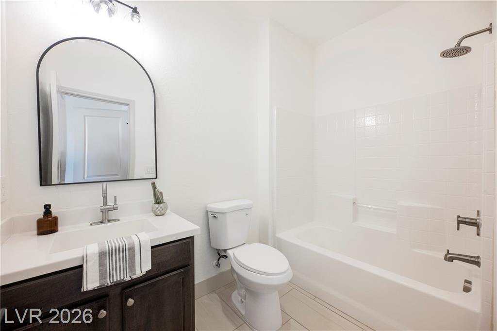 Junior suite bath with arched mirror, tub and shower at 2430 Quiet Ode Street