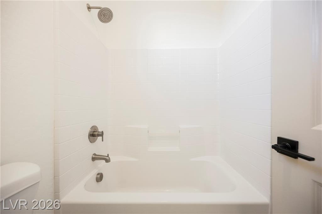 Tub and shower combination with white tile surround