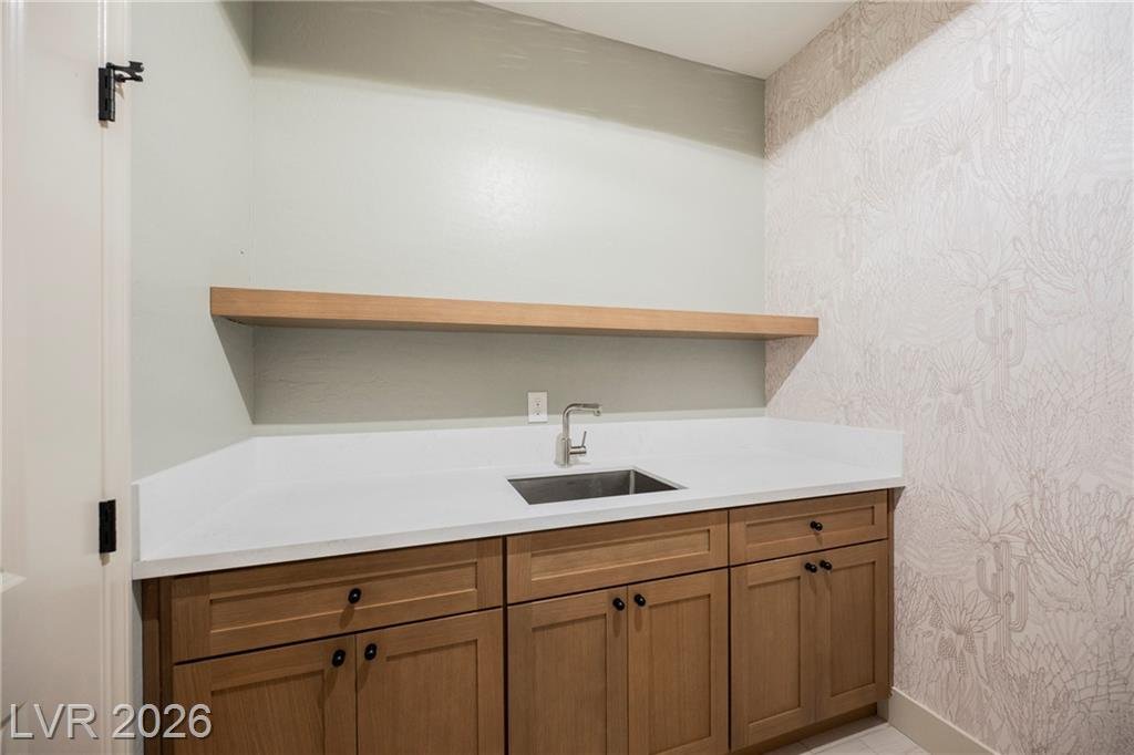 Laundry room utility sink, quartz counter and floating shelf at 2430 Quiet Ode Street