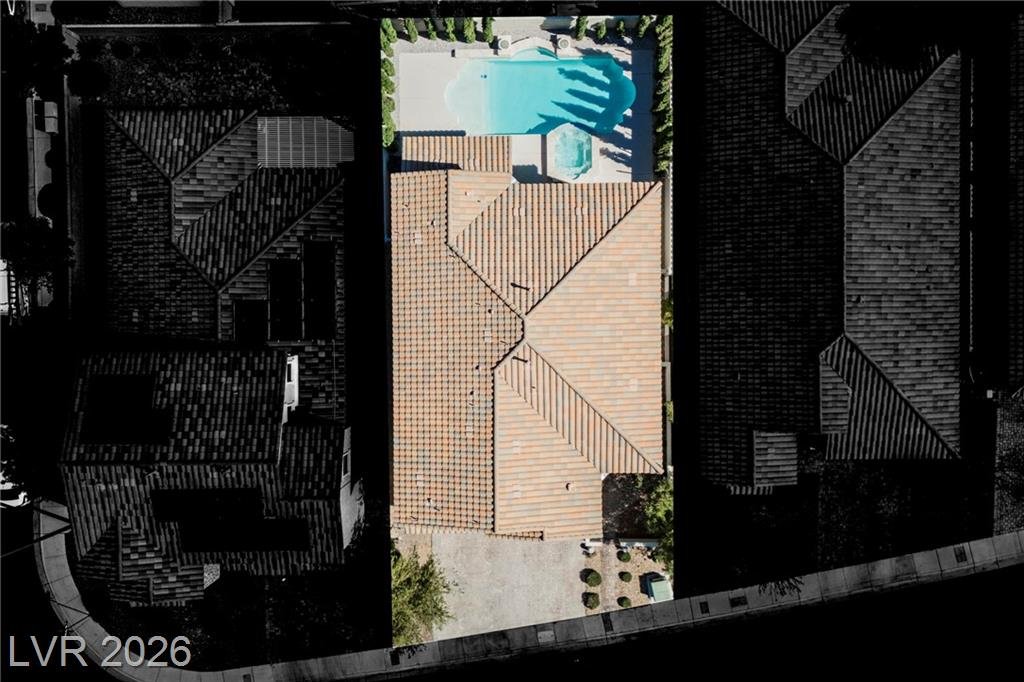 Aerial view of the lot showing the pool, spa and tile roof