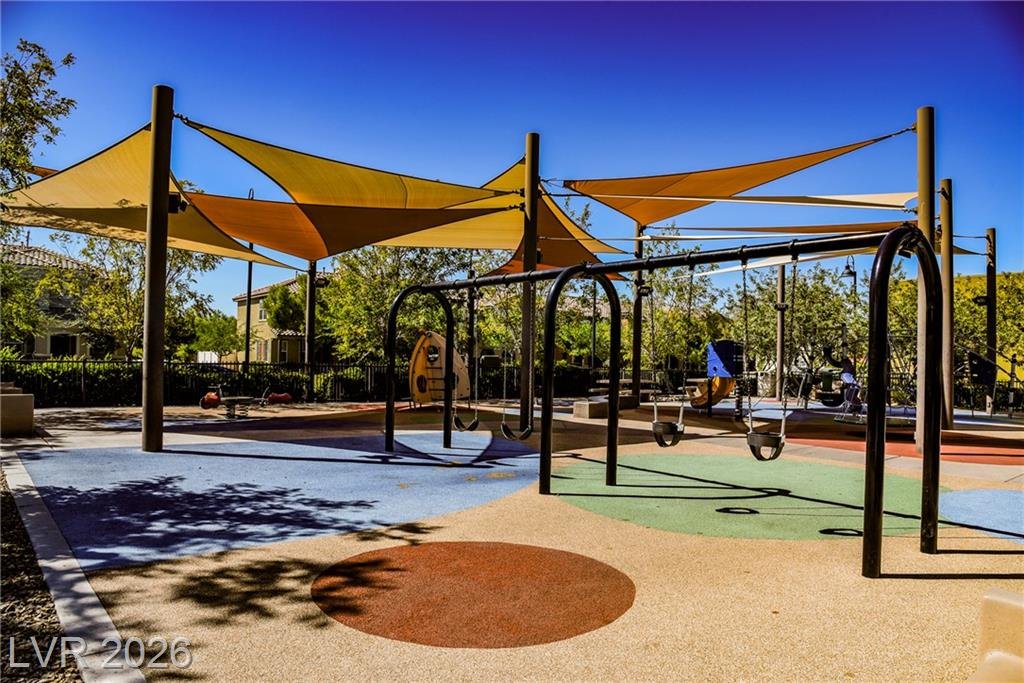 Shaded playground with swings at a nearby community park