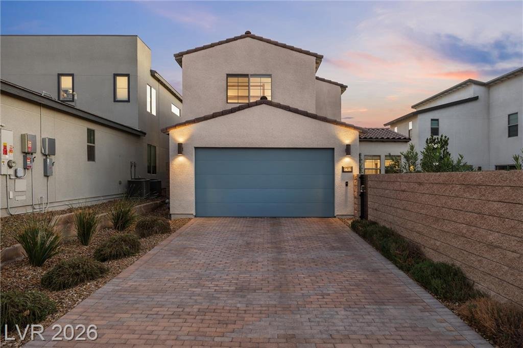 Extra-long paver driveway leading to the two-car garage at 2702 Marchetti Place