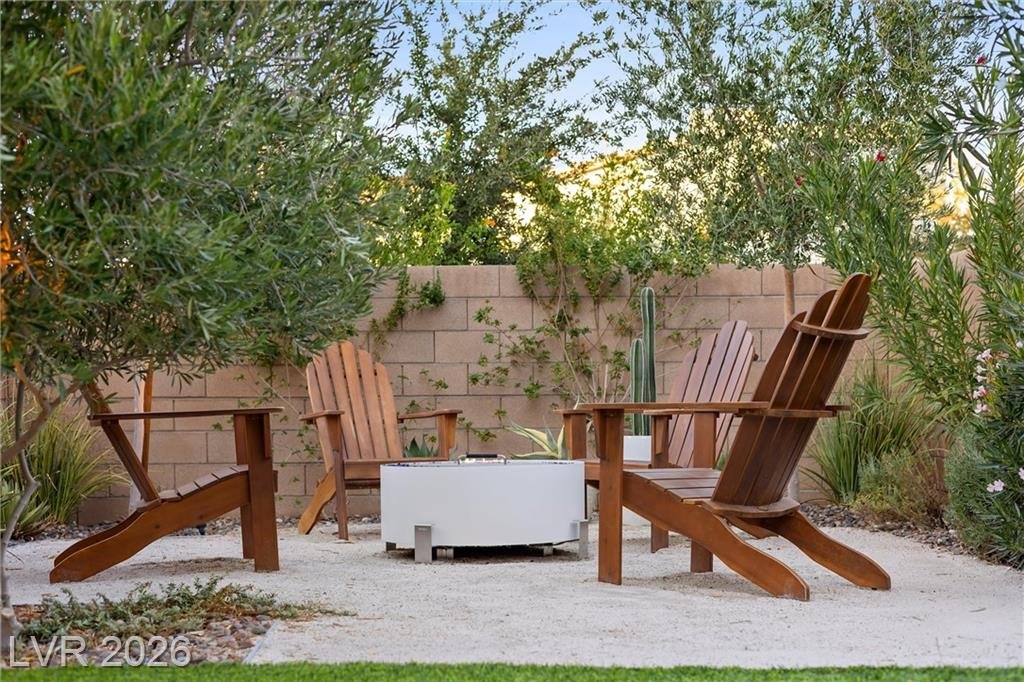 Fire pit and wood Adirondack chairs in the backyard at 2702 Marchetti Place