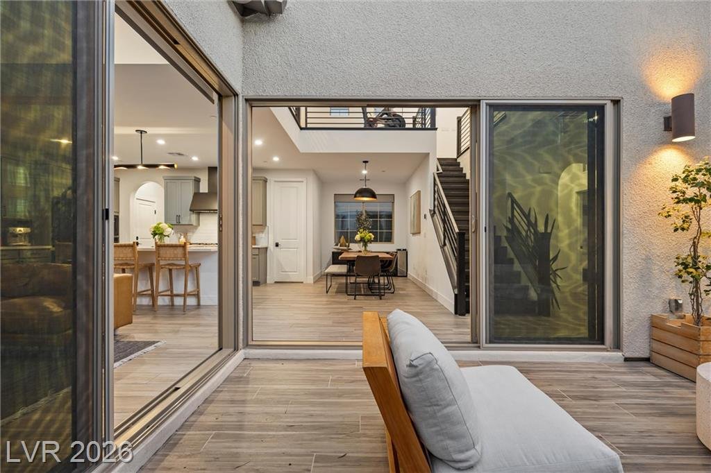 Open slider from the courtyard looking into the dining area and staircase