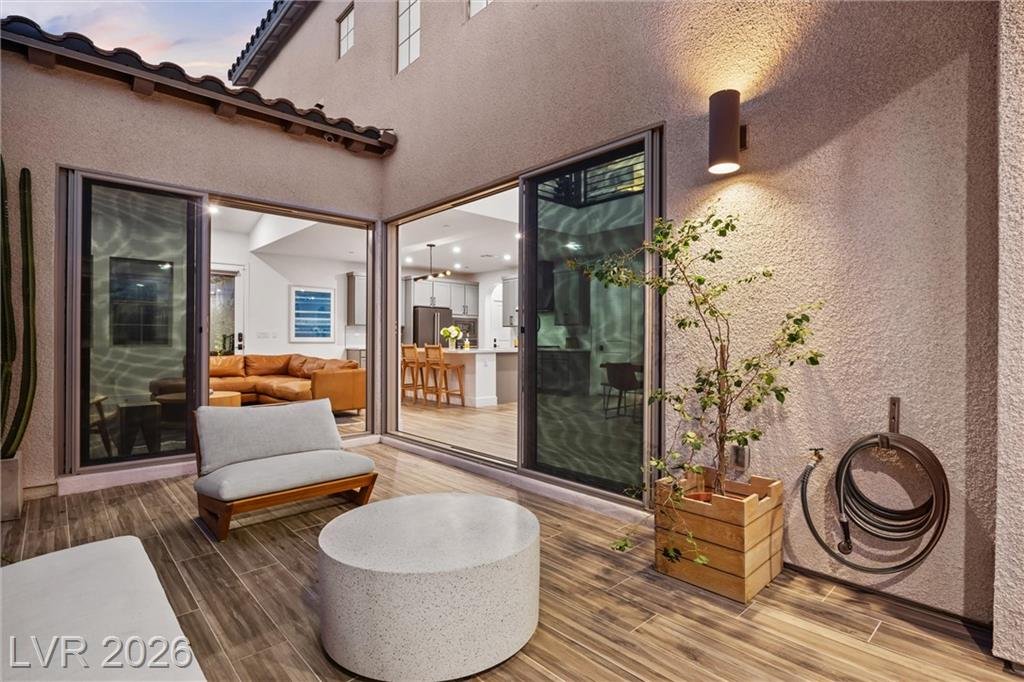Courtyard planter, lounge chair and open slider to the great room