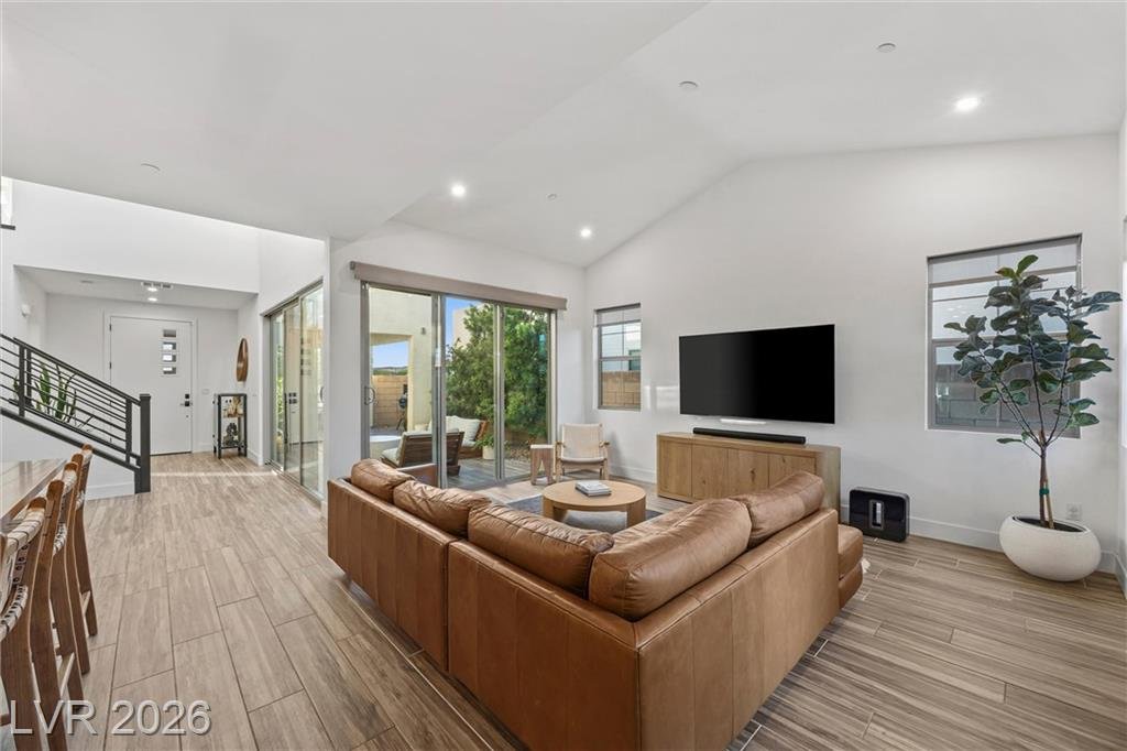 Great room with a sectional sofa, TV wall and the stair rail beyond