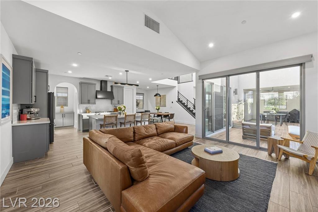 Vaulted great room at 2702 Marchetti Place with a sectional and an open kitchen