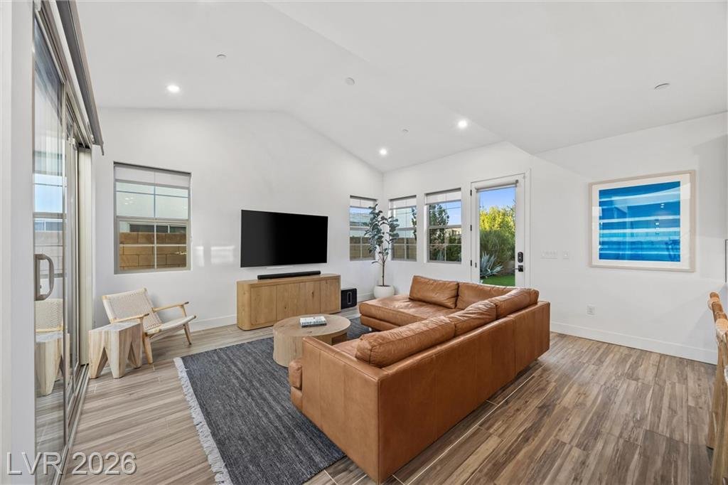 Great room TV wall with windows and a door to the side yard