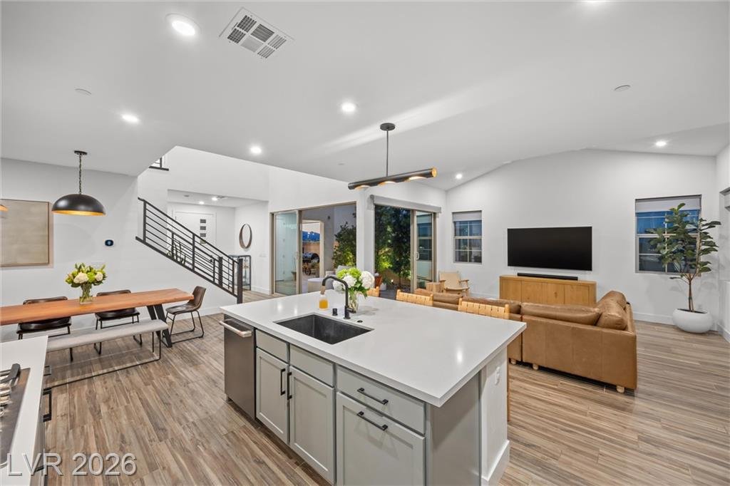 Island sink with matte black faucet beside the dining table