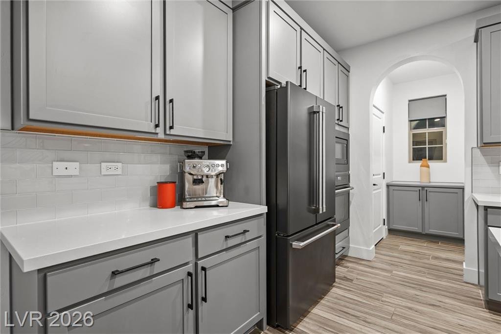 Coffee bar corner, black stainless refrigerator and walk-in pantry door